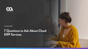 Three colleagues reviewing a financial dashboard on a laptop, with the headline 7 Questions to Ask About Cloud ERP Services.